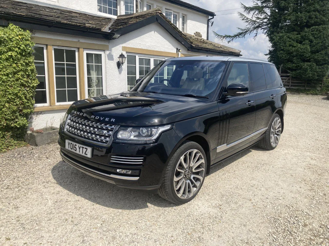 Black Range Rover on a driveway being rust-proofed by Mobile Rust Doctor